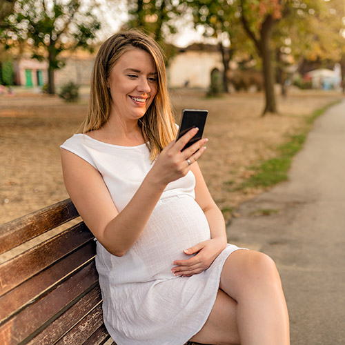 Pregnant woman sitting in the park.