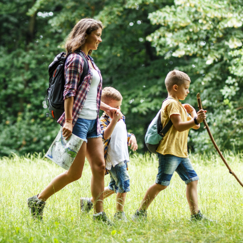 Mother with two sons hiking.